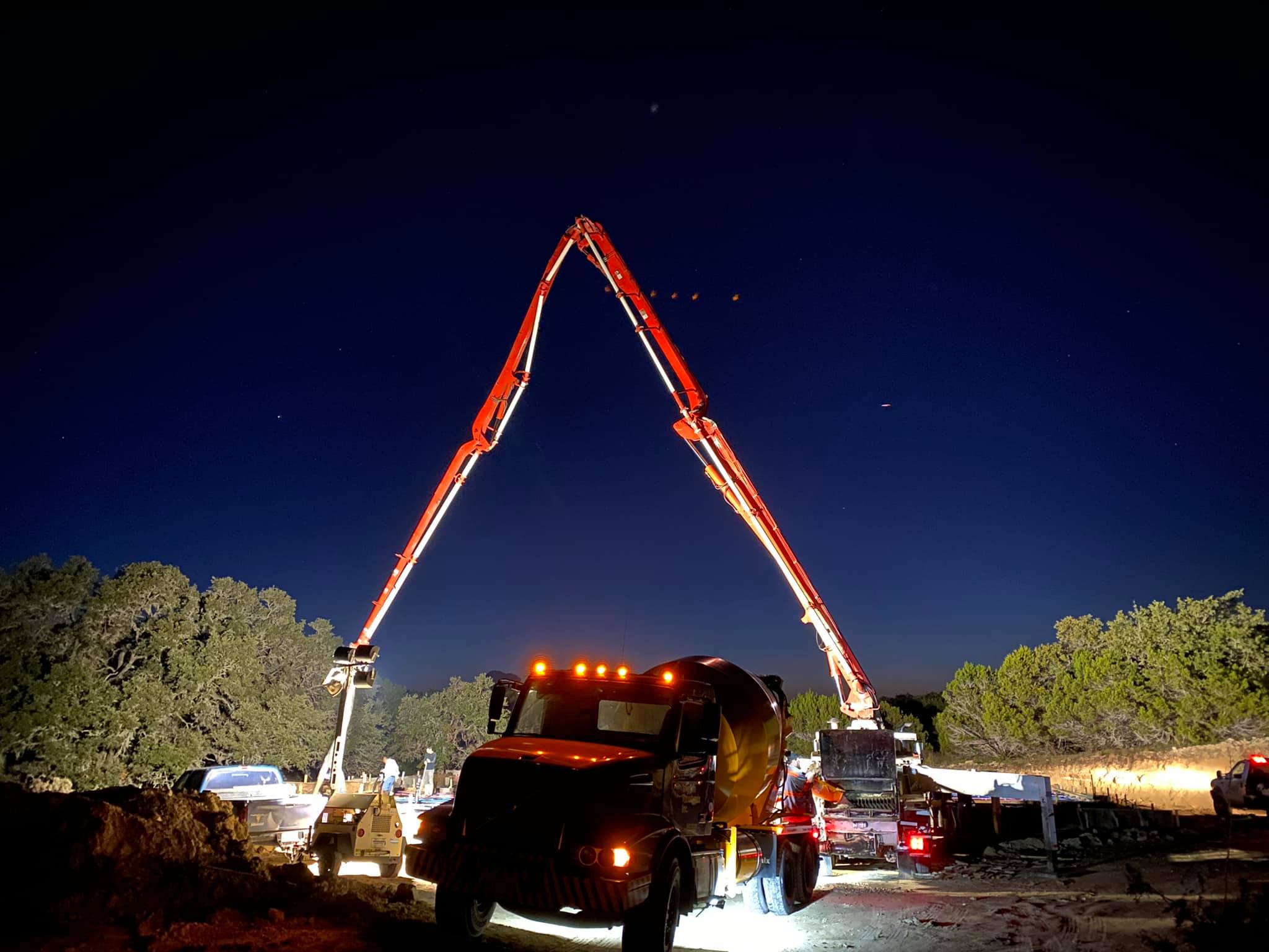 Night concrete foundation pour with pump truck under the stars